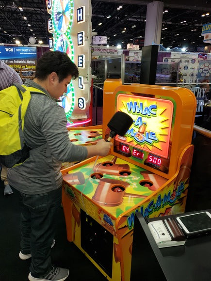 Person playing an arcade game at a convention center