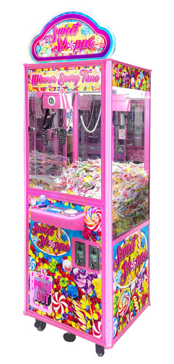 A pink and multicolored candy-themed arcade crane game machine.