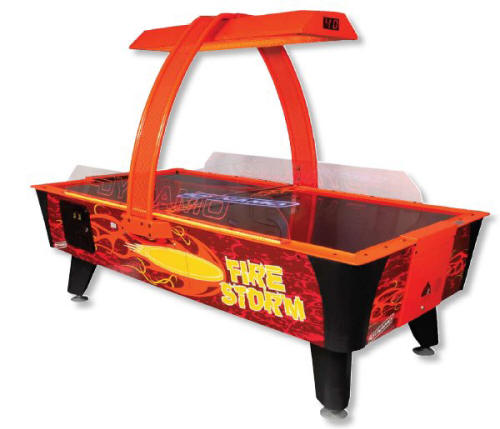 Commercial air hockey table with red and black colors, featuring a glowing playing surface and overhead structure with LED lighting.