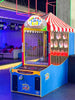 An arcade game titled 'ICE Down The Clown' featuring a colorful cabinet with a carnival-style canopy, LED lighting, and a digital score display.