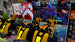 Simulator racing chairs in an arcade with video game displays on the wall.