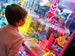 Child playing with a claw machine in an arcade setting