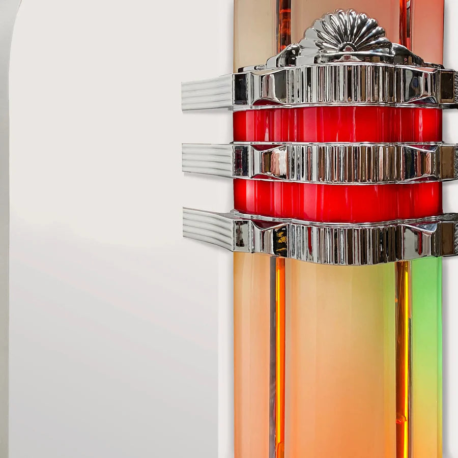 Decorative wall sconce with red central light and silver accents on a white background